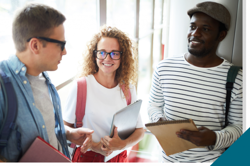 Four casual intercultural college friends with backpacks chatting about summer vacations at break